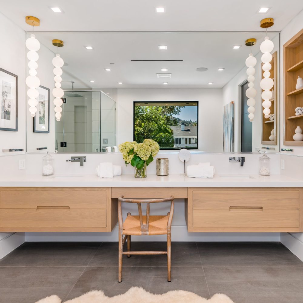Contemporary bathroom with dual sinks, vanity, and mirrors